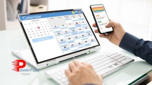 Professional using social media content calendar on laptop and mobile device for strategic marketing planning.